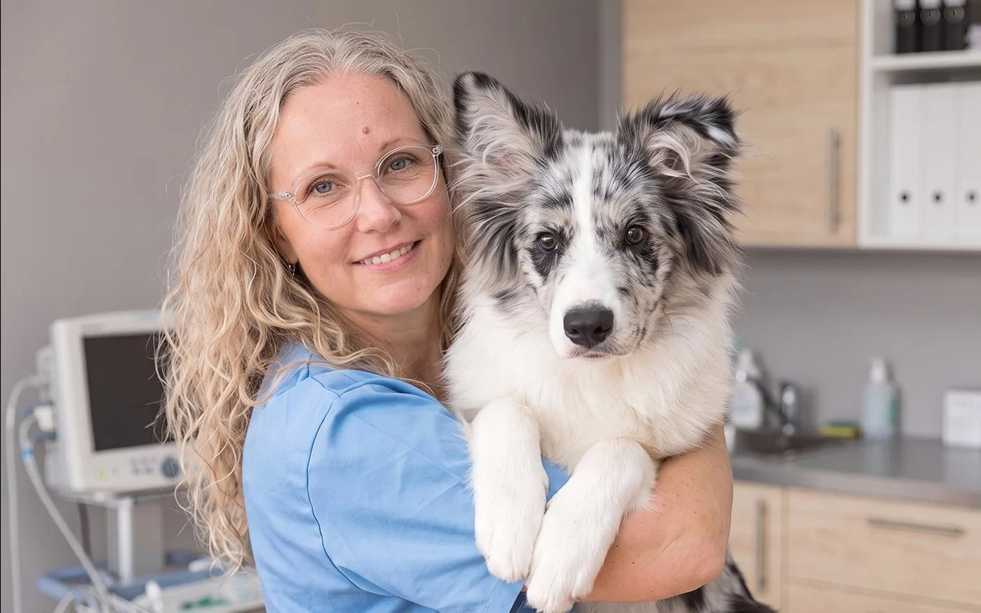 Dr. Kathryn Dench holding a dog at her clinic
